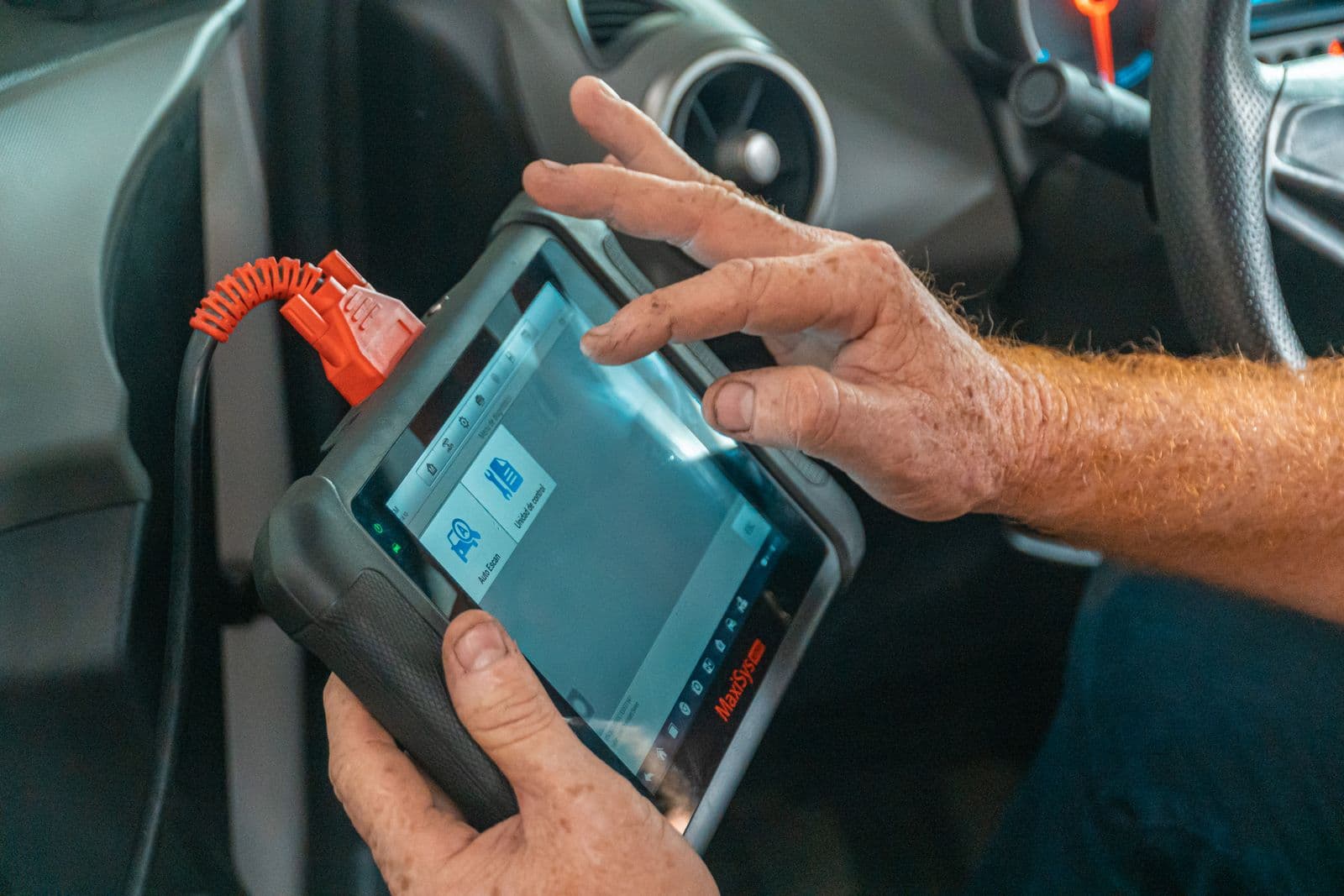 A technician using an automotive diagnostic scanner.