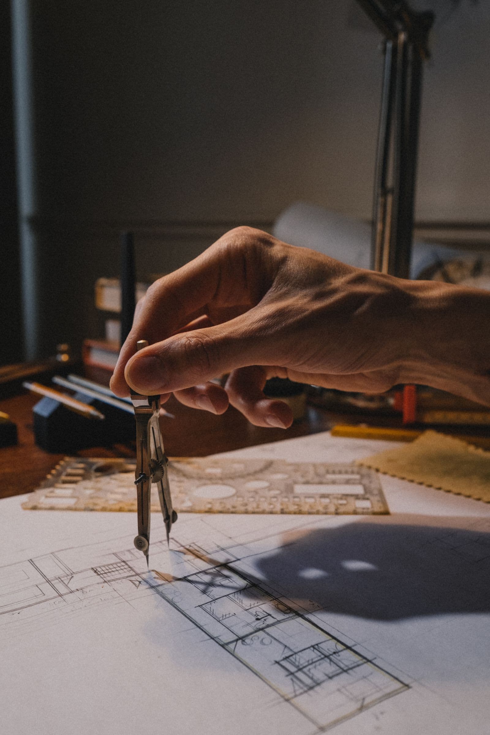 A professional working from a detailed technical drawing.